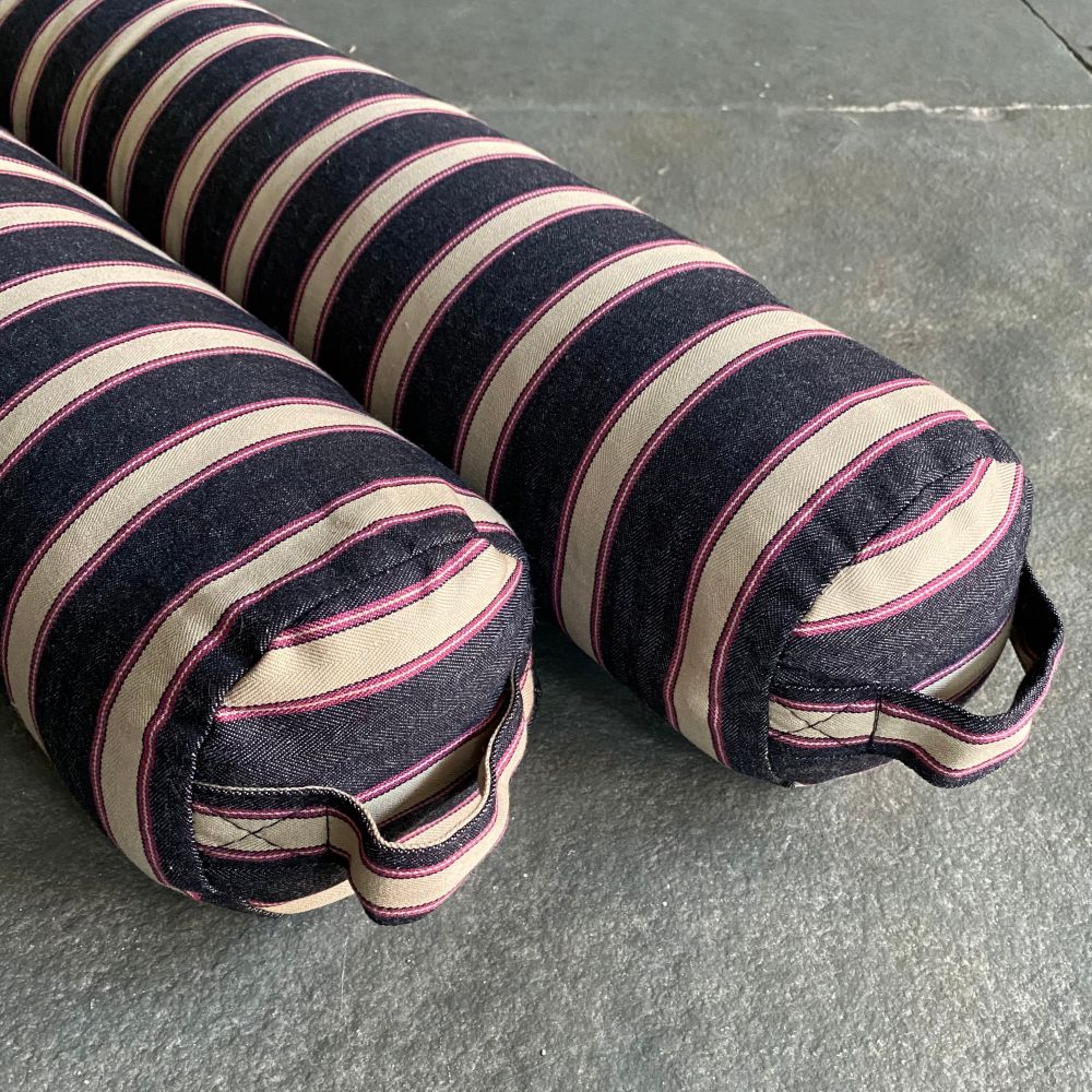 Pair of Striped Draught Excluders on a grey stone floor