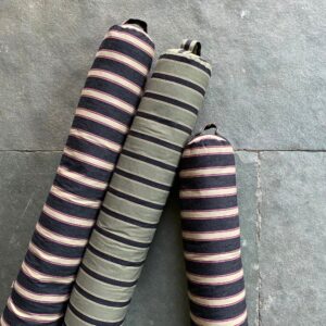 Trio of Striped Draught Excluders on a grey stone floor