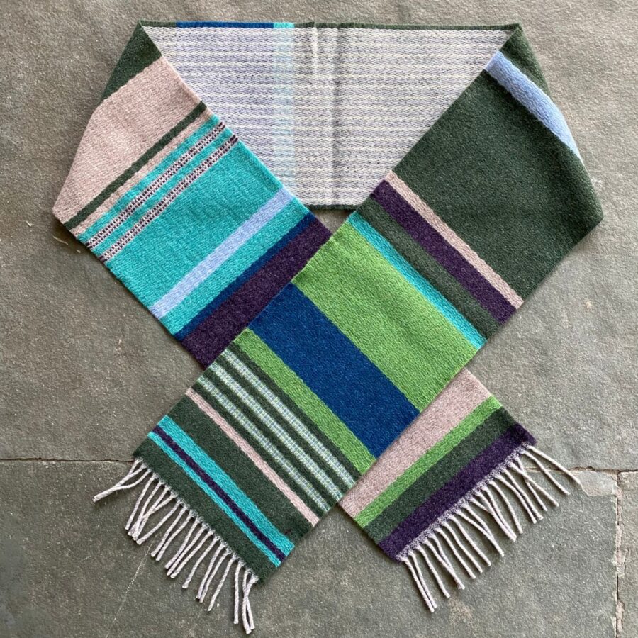 Wallace + Sewell striped wool scarf in a loop on a stone floor