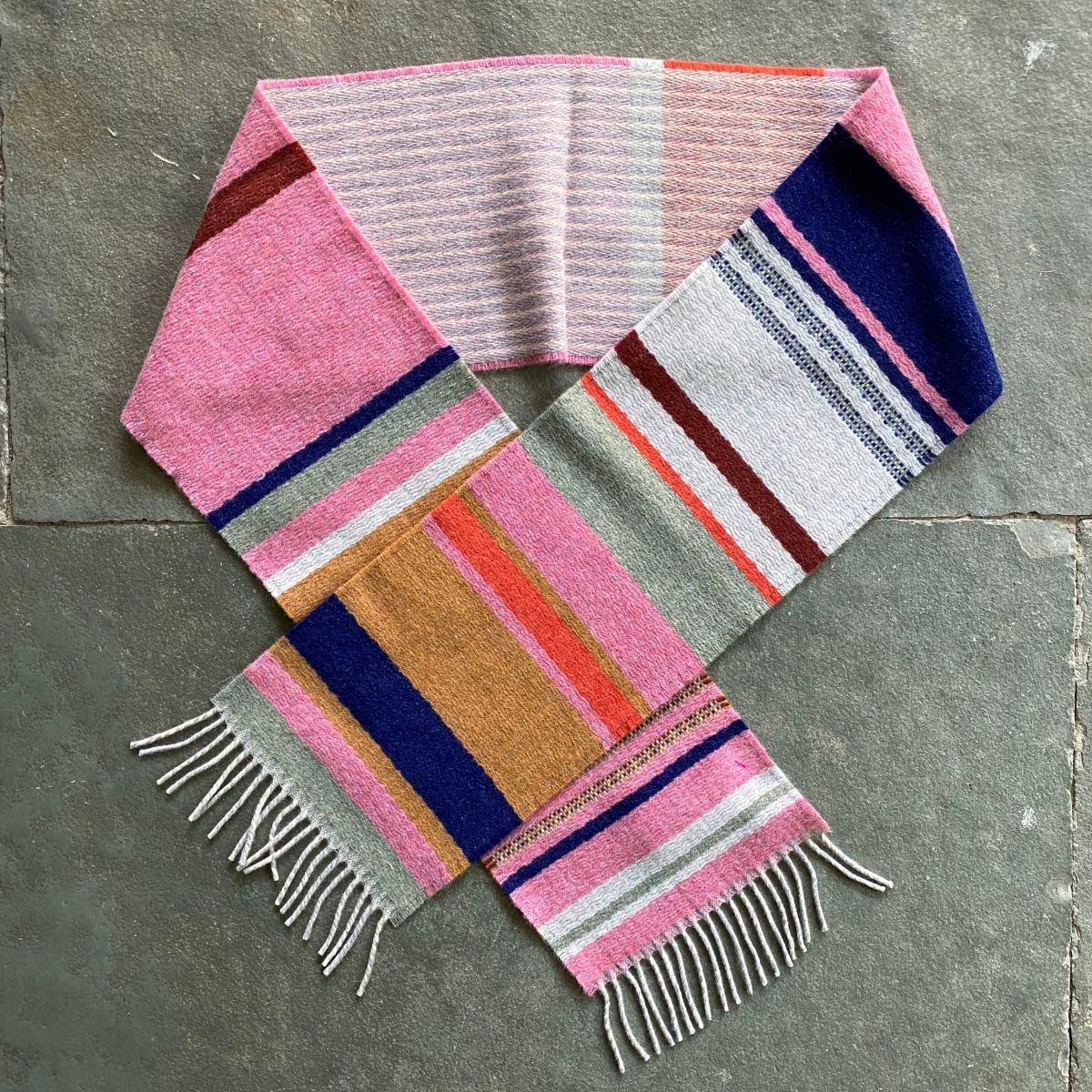 Wallace + Sewell Striped Scarf in a circle on a stone floor