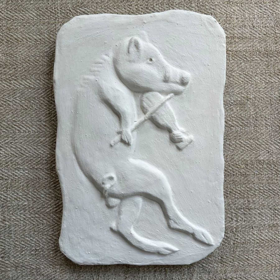 Pargetted lime plaster relief featuring boar with a fiddle