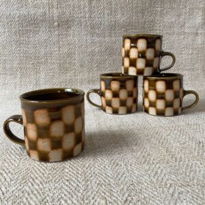 A striking mug with checked design by Norwich potter, Edmund Davies. 