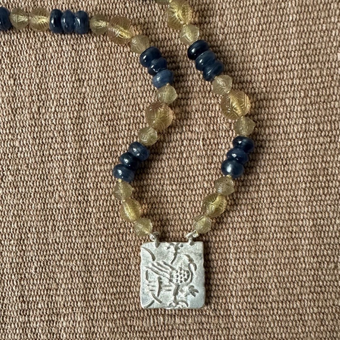 Silver Hawk necklace with blue and amber beads